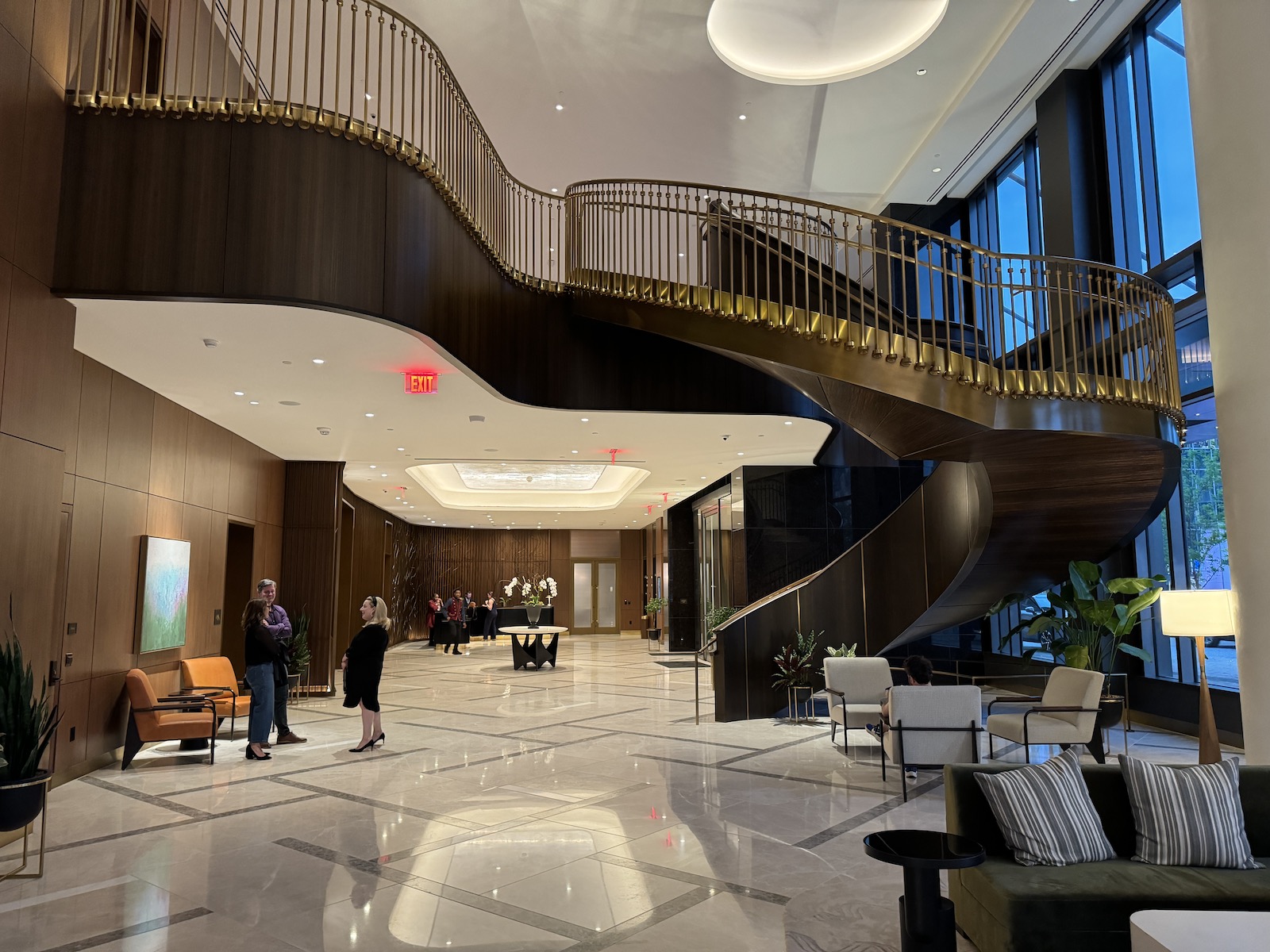 a large lobby with a staircase and people