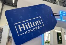 Why I Love Having Stacks On Stacks Of Hilton Credits Now a blue and white sign with white text