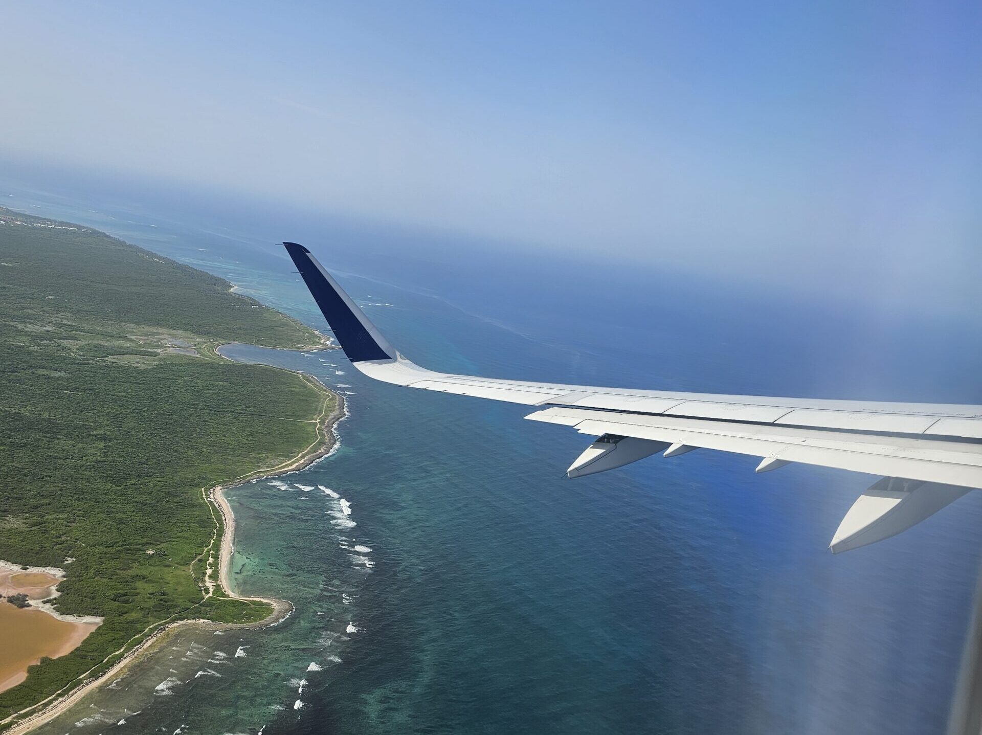 an airplane wing above a body of water