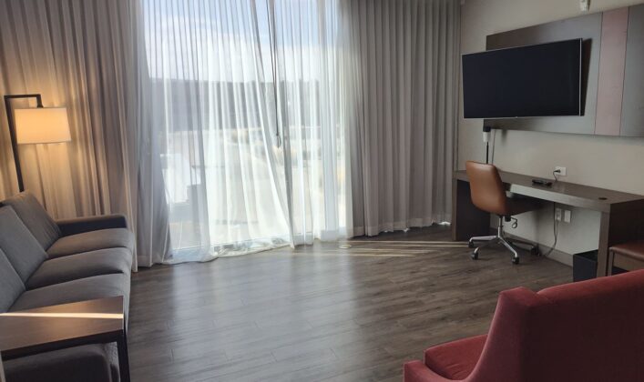 a room with a tv and a wood floor