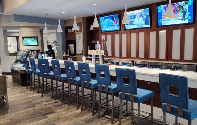 a row of blue chairs in a bar