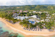 22 Bahia Principe Resorts Joining World of Hyatt a beach with a group of buildings and trees