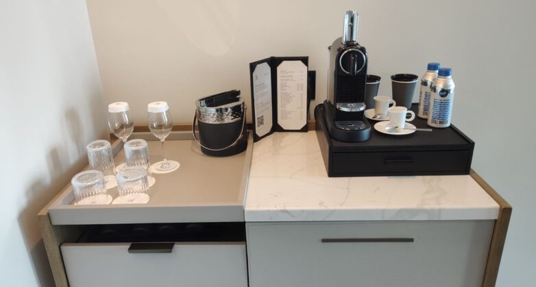 a coffee machine and glasses on a counter