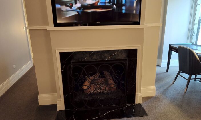 a tv on a wall above a fireplace