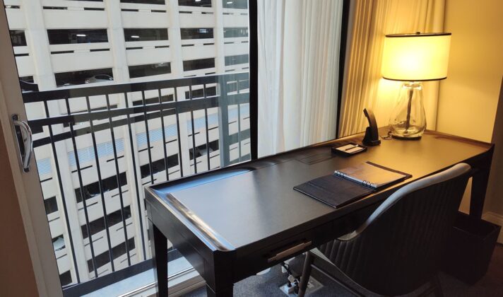 a desk with a lamp and a notebook on it