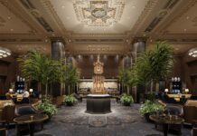 Waldorf Astoria New York Goes Up for Sale a room with a gold statue and palm trees