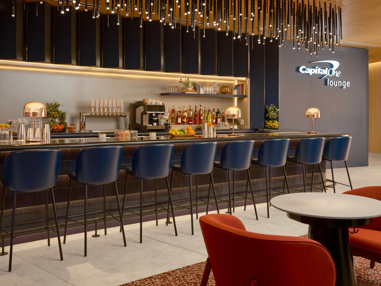 a bar with blue chairs and a blue sign