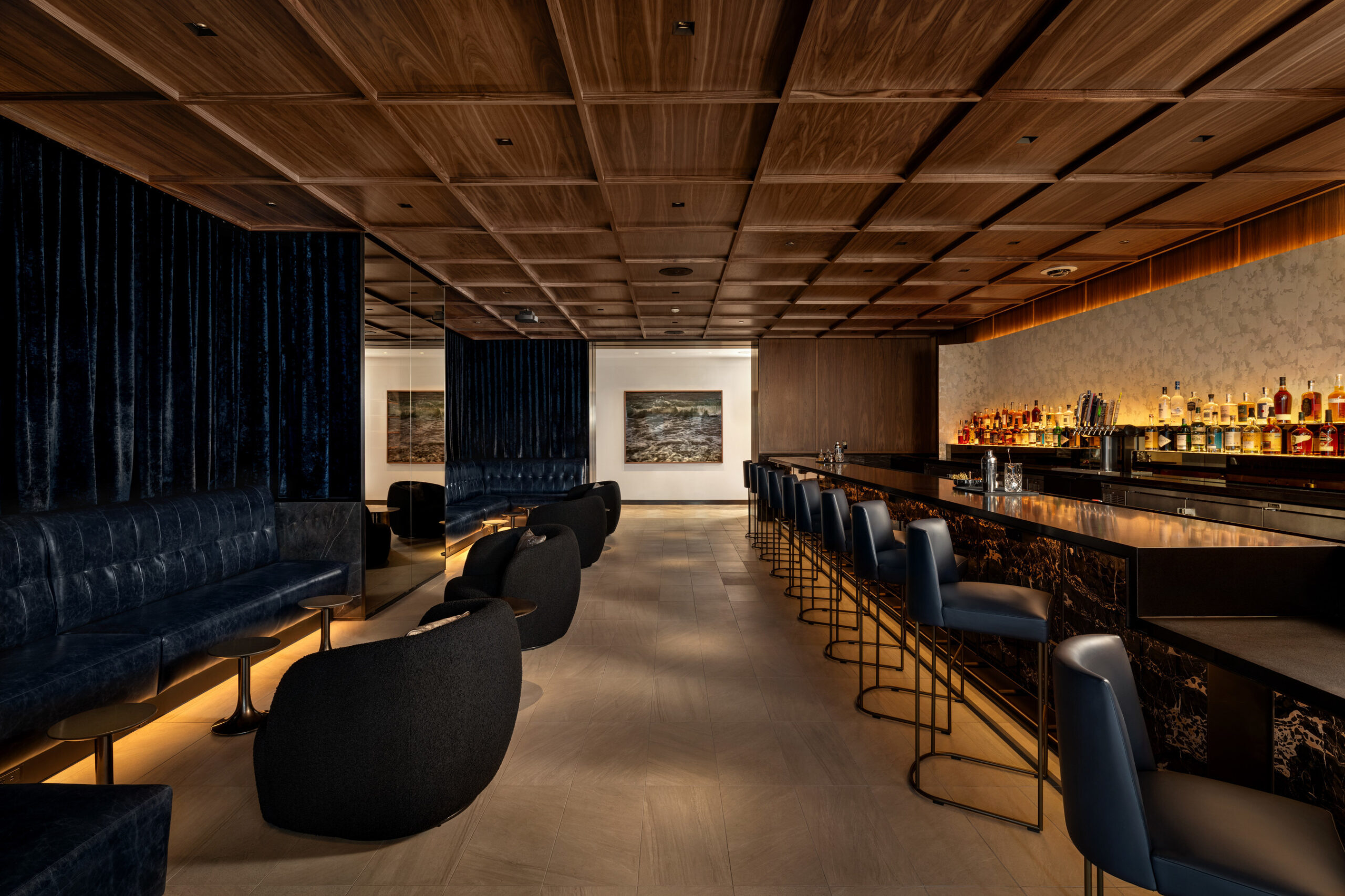 a room with a bar and chairs